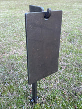 Load image into Gallery viewer, A 6inx11in 3/8in AR500 A Zone steel shooting target with a 30in 3/8in AR500 ground stake stand with integrated hook for mounting, placed in grass.