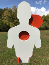 Load image into Gallery viewer, A 12inx21in 3/8in AR500 white and orange steel shooting target with interlocking swinging paddles and a Studded T-post mount outdoors.