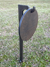 Load image into Gallery viewer, A 8in 3/8in AR500 steel shooting target with a 30in 3/8in AR500 ground stake stand with integrated hook for mounting, placed in grass.