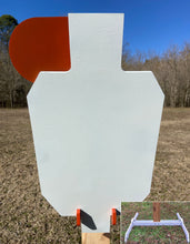 Load image into Gallery viewer, A 12inx20in 3/8in AR500 white and orange steel shooting target with an interlocking swinging paddle, accompanied by a 2x4 mount and stand, set outdoors.