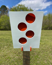 Load image into Gallery viewer, A 12inx18in 3/8in AR500 white and orange steel shooting target with interlocking swinging paddles, accompanied by a 2x4 mount and stand, set outdoors.