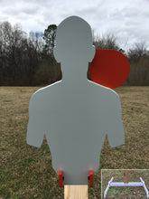 Load image into Gallery viewer, A 12inx21in 3/8in AR500 white and orange steel shooting target with interlocking swinging paddles, accompanied by a 2x4 mount and stand, set outdoors.