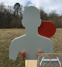 Load image into Gallery viewer, A 11inx13in 3/8in AR500 white and orange steel shooting target with an interlocking swinging paddle, accompanied by a 2x4 mount and stand, set outdoors.