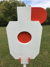 Load image into Gallery viewer, A 12inx20in 3/8in AR500 white and orange steel shooting target with interlocking swinging paddles and a Studded T-post mount outdoors.