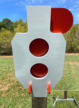 Load image into Gallery viewer, A 9.5inx17in 3/8in AR500 white and orange steel shooting target with interlocking swinging paddles, accompanied by a 2x4 mount and stand, set outdoors.