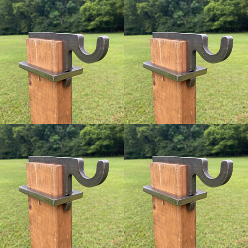 four wooden 2x4 posts with four 3/8in AR500 metal bracket hooks against a grassy background for steel targets