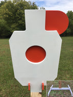 A 12inx20in 3/8in AR500 white and orange steel shooting target with interlocking swinging paddles, accompanied by a 2x4 mount and stand, set outdoors.