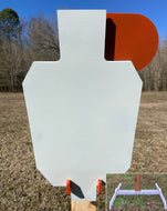 A 15inx30in 3/8in AR500 white and orange steel shooting target with interlocking swinging paddles, accompanied by a 2x4 mount and stand, set outdoors.