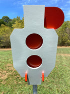 A 9.5inx17in 3/8in AR500 white and orange steel shooting target with interlocking swinging paddles and a Studded T-post mount outdoors.
