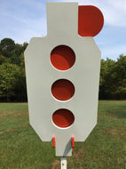 A 13inx30in 3/8in AR500 white and orange steel shooting target with interlocking swinging paddles and a Studded T-post mount outdoors.